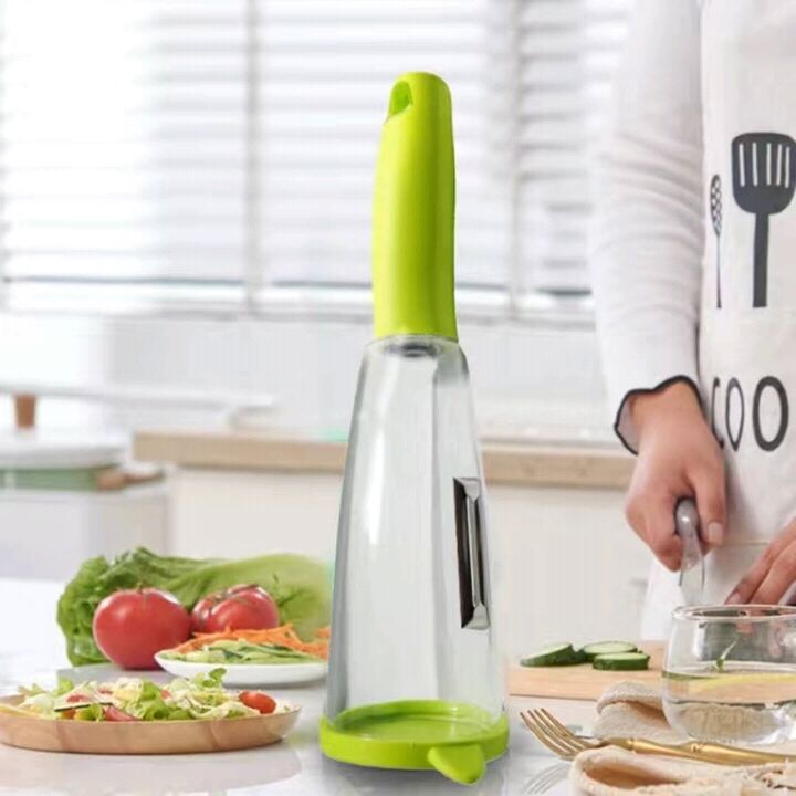 Kitchen tool with green handle and clear body on a kitchen counter with food and utensils.