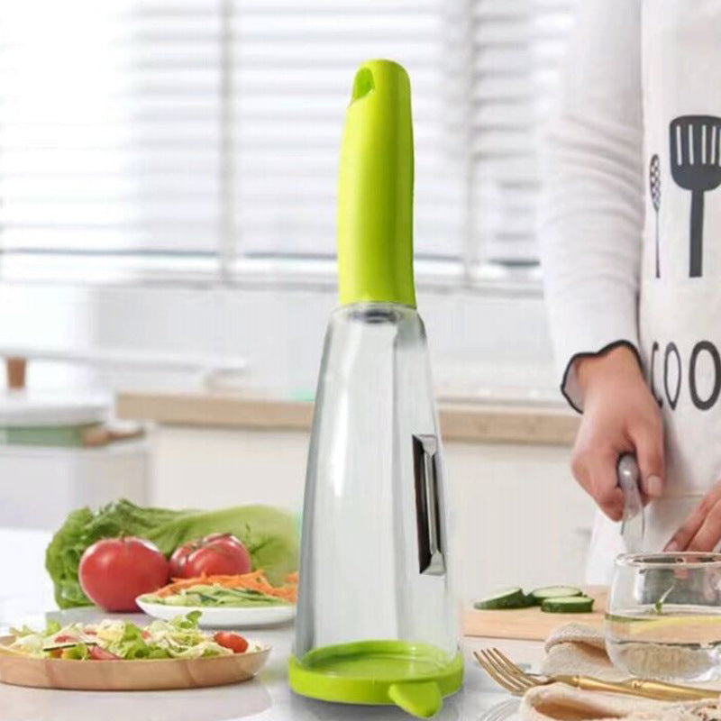 Clear bottle with green cap on a kitchen counter with vegetables and utensils.