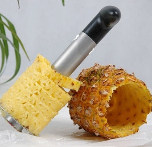 Pineapple peeler with a pineapple on a light gray background
