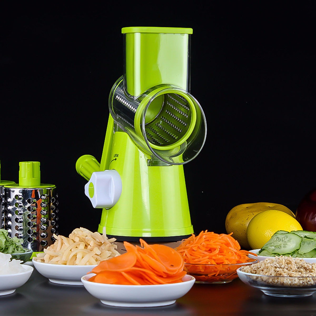 Green manual vegetable spiralizer with sliced vegetables on a black background