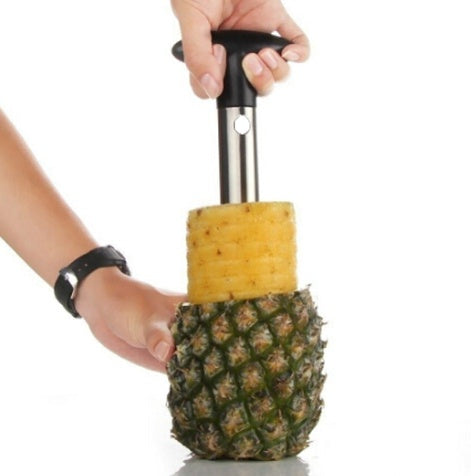 Pineapple being cut with a pineapple cutter on a white background