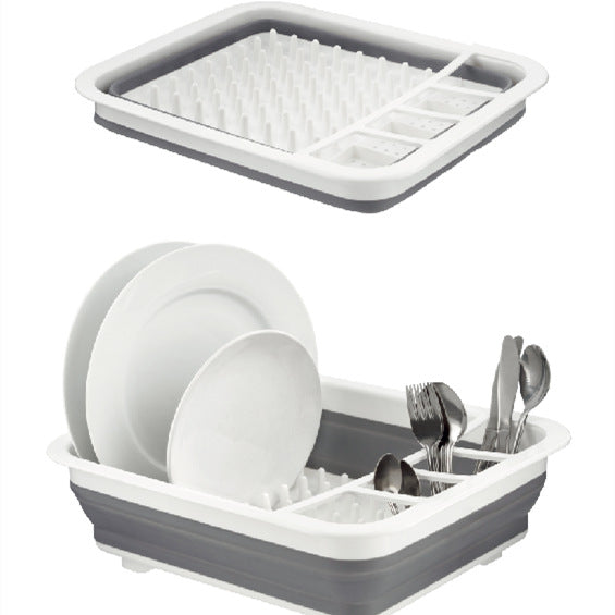 Gray and white dish drying rack with dishes and utensils on a white background