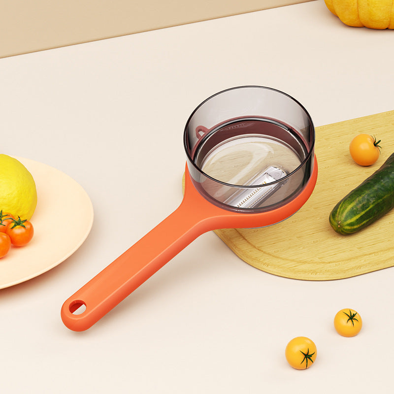 Orange kitchen strainer on a white surface with vegetables around
