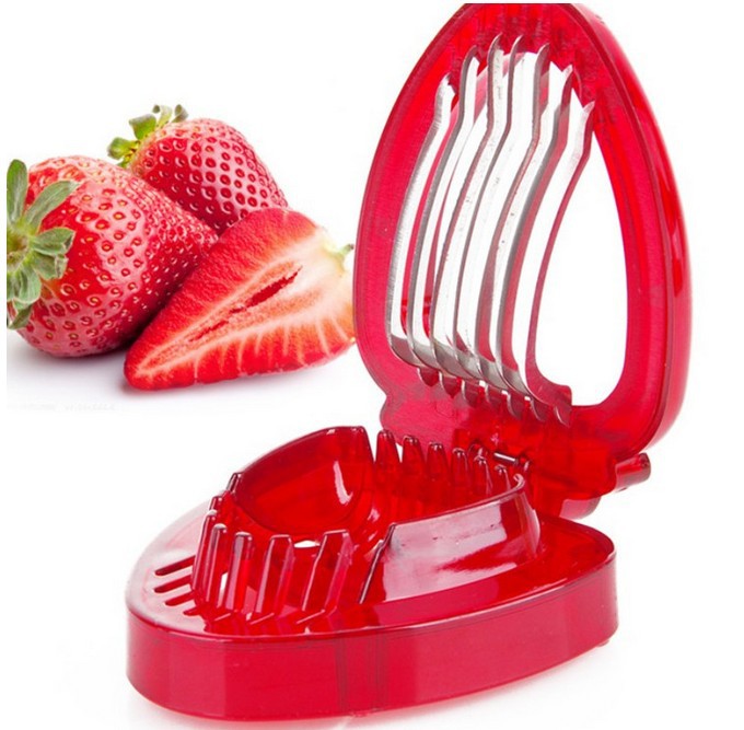 Red strawberry slicer with fresh strawberries on a white background