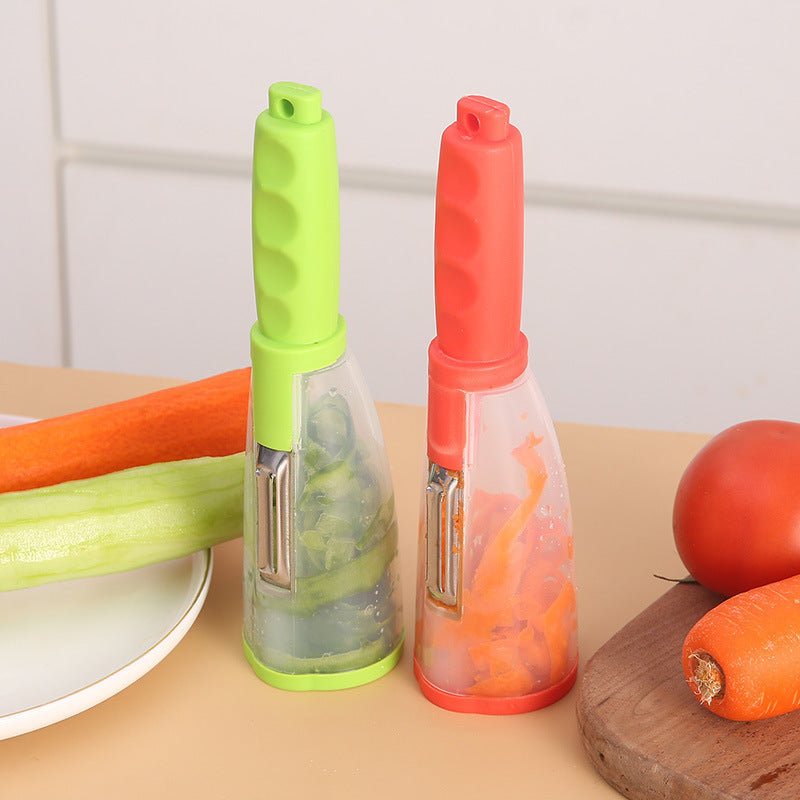 Two vegetable peelers, one green and one red, on a kitchen counter with vegetables.