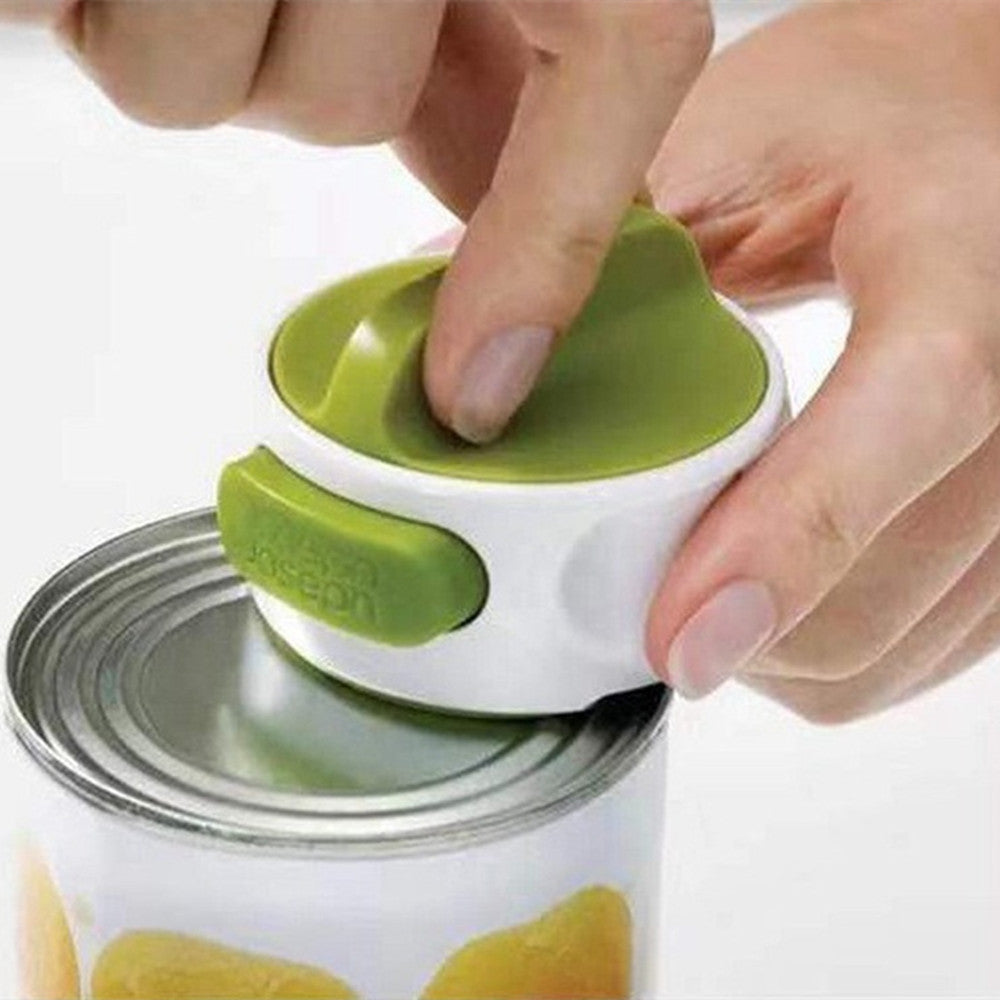Hand using a can opener with a green handle on a white background